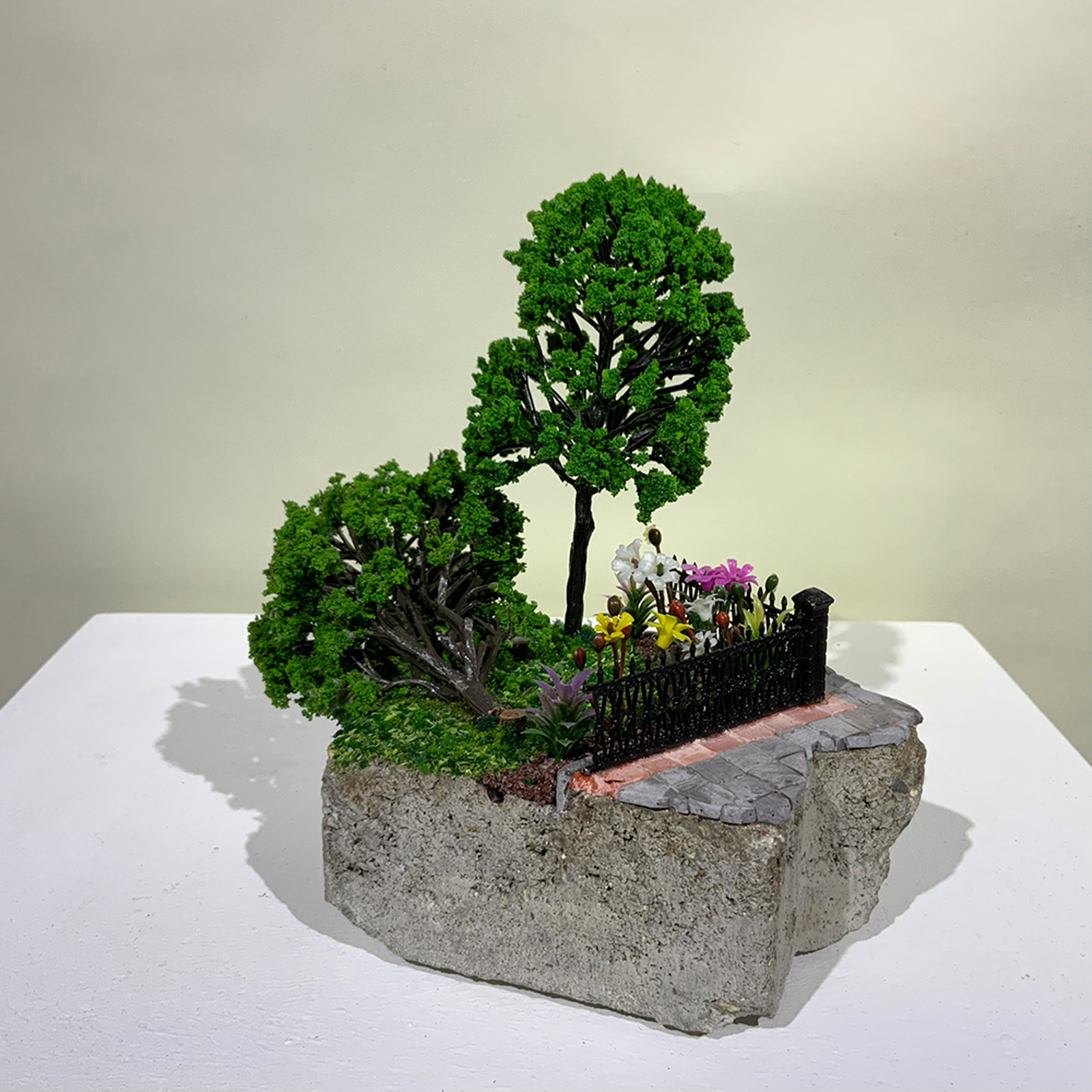 A small-scale sculpture of a fallen tree from On the Rubble of Our Ancestors