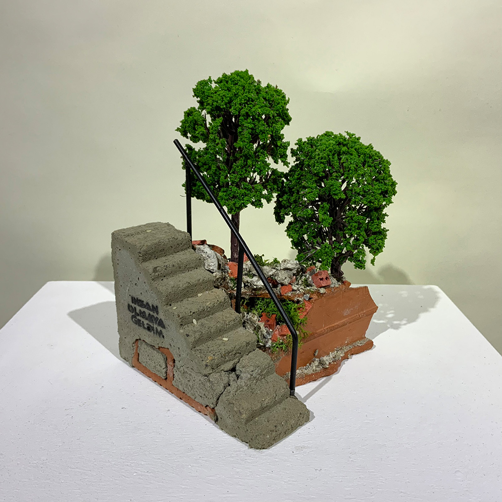 A small-scale sculpture of a stepped landscape from On the Rubble of Our Ancestors
